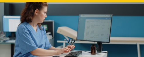 medical professional typing on a computer